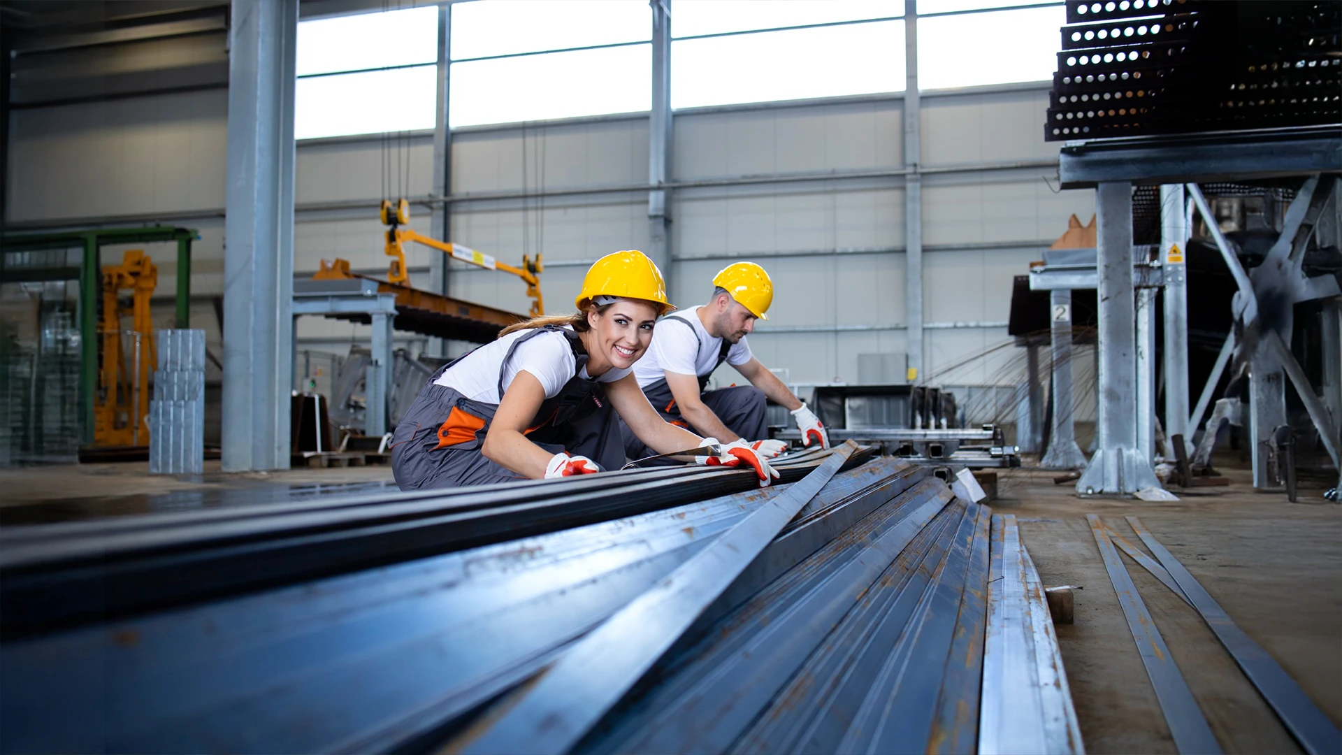 Workers handling metal beams for construction and installation during home maintenance services in Dubai.