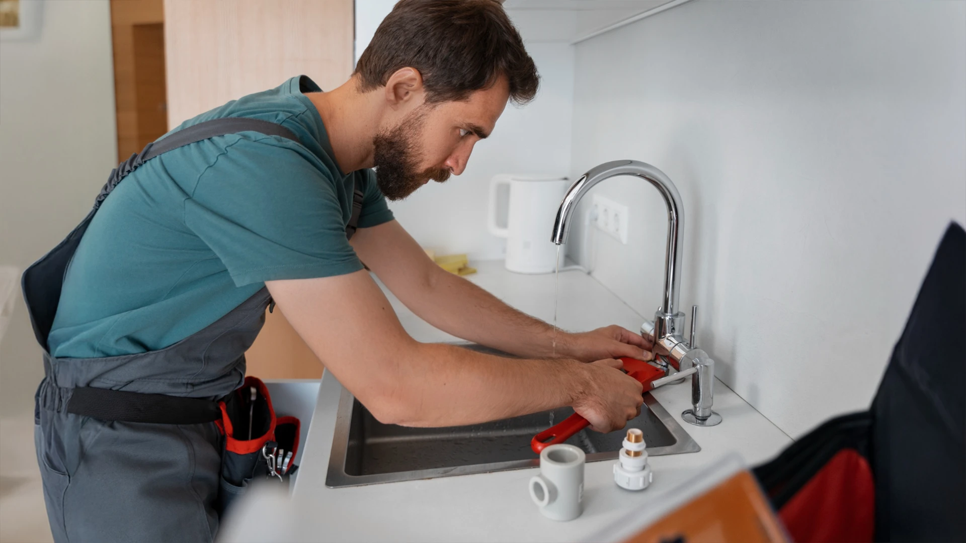 Technician performing kitchen sink repairs as part of home repair services in Dubai.