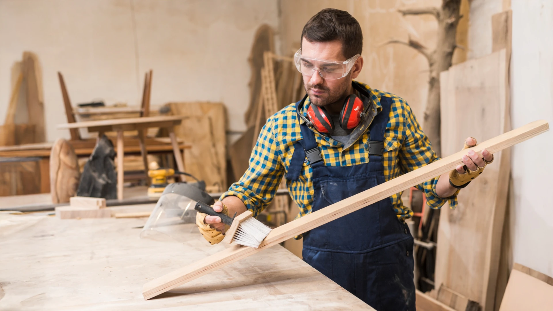 Applying varnish on wood during expert wooden work services in Dubai.